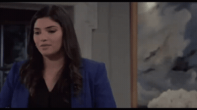Woman In Blue Jacket In Front Of Painting GIF