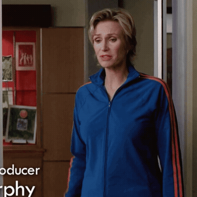 Woman In Blue Jacket In Front Of Producer Graphy Sign GIF