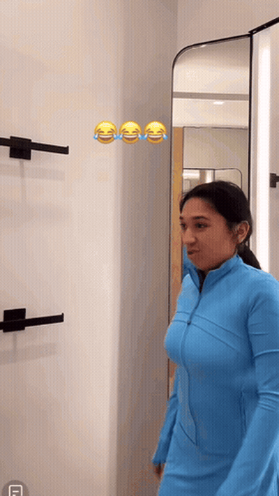Woman In Blue Jacket Laughing At Mirror GIF