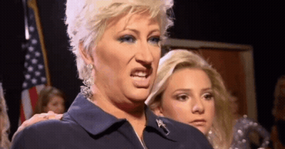 Woman In Blue Jacket Making Funny Face GIF