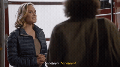 Woman In Blue Jacket Man Saying Nineteen Nineteen GIF