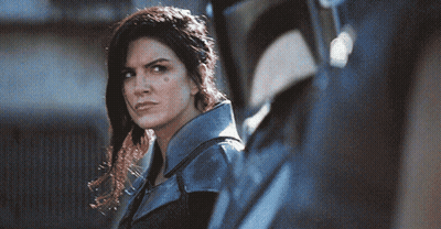 Woman In Blue Jacket Next To Man In Black Helmet GIF
