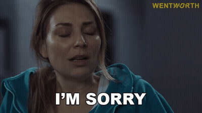 Woman In Blue Jacket Saying I'm Sorry At Wentworth Sign GIF