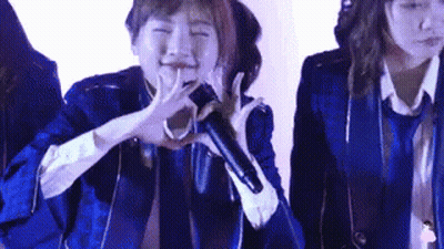 Woman In Blue Jacket Singing Into Microphone GIF