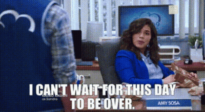 Woman In Blue Jacket Sitting At Desk Saying I Can't Wait For This Day To Be Over GIF