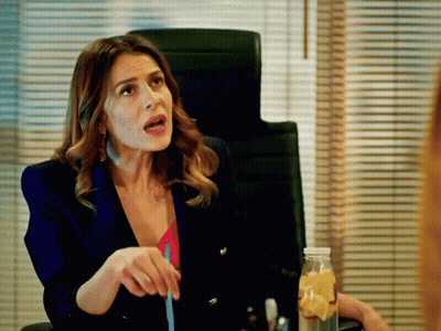 Woman In Blue Jacket Sitting At Desk With Lemonade GIF