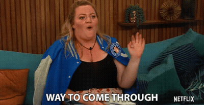 Woman In Blue Jacket Sitting On Couch Says Way To Come Through GIF