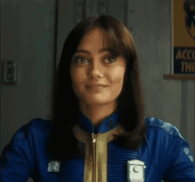 Woman in Blue Jacket Smiling at Account Them Sign