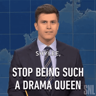 Woman In Blue Jacket Talking At Counter GIF