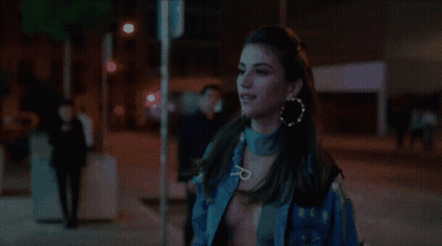 Woman In Blue Jacket Walking City Street At Night GIF