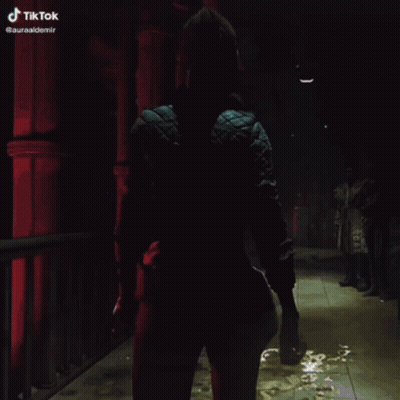 Woman In Blue Jacket Walking Dark Hallway TikTok GIF
