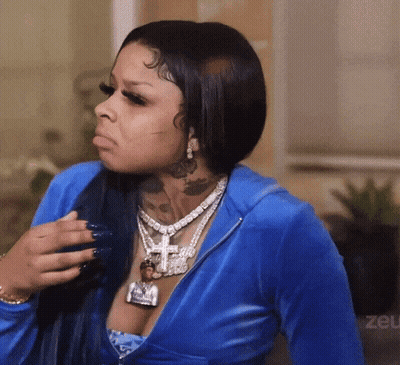 Woman In Blue Jacket With Cross Necklace GIF