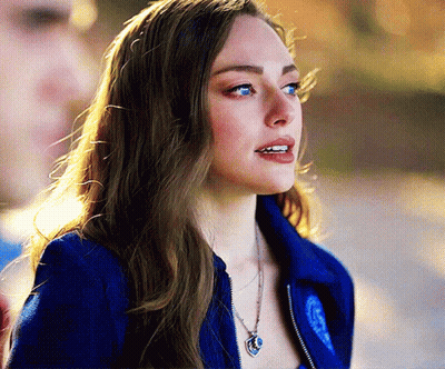 Woman In Blue Jacket With Heart Necklace GIF