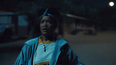 Woman In Blue Jacket With Pendant Saying I GIF