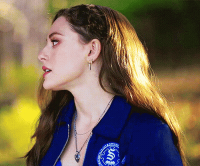 Woman In Blue Jacket With S Necklace GIF