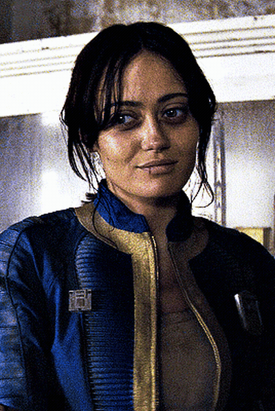 Woman In Blue Jacket With Vault Boy Badge GIF