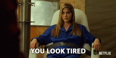Woman In Blue Jumpsuit Sitting Says You Look Tired GIF