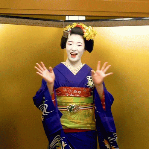 Woman In Blue Kimono Waving Hands Gold Background GIF
