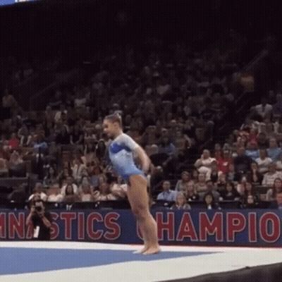 Woman In Blue Leotard Doing Gymnastics Trick GIF