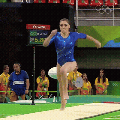 Woman In Blue Leotard Doing Trampoline Trick GIF