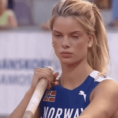 Woman In Blue Norway Shirt Holding Pole GIF