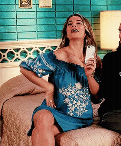 Woman In Blue Off The Shoulder Dress Holding Cell Phone GIF