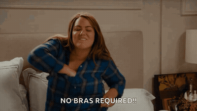 Woman In Blue Plaid Shirt Holding Breasts Saying No Bras Required GIF