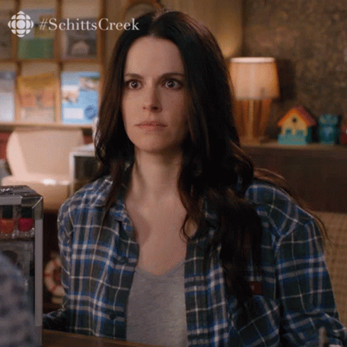 Woman In Blue Plaid Shirt Sitting At Table #SchittsCreek GIF