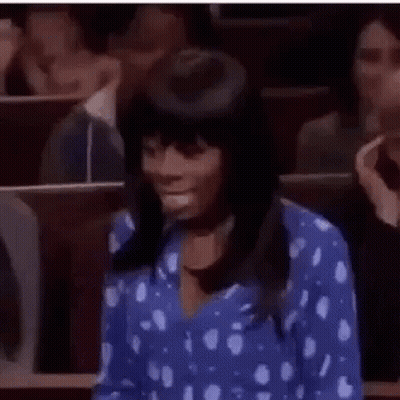 Woman In Blue Polka Dot Shirt Sitting Classroom GIF
