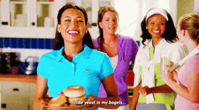 Woman In Blue Polo Holding Bagels Saying I Like Yeast In My Bagels GIF