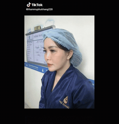 Woman In Blue Robe And Surgical Cap At Whiteboard Saying Tik Tok GIF