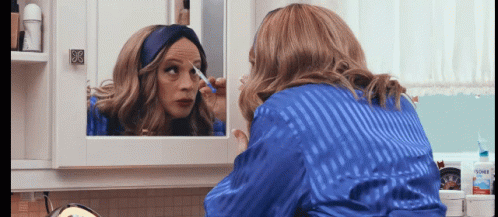 Woman In Blue Robe Applying Makeup GIF