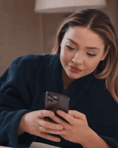 Woman In Blue Robe Checking Phone GIF