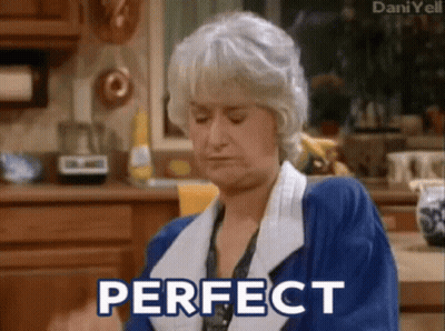 Woman In Blue Robe Sitting In Kitchen GIF
