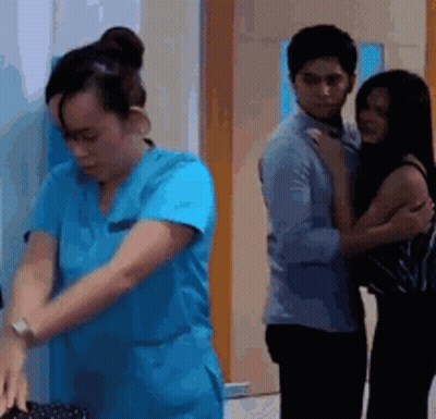 Woman In Blue Scrub Next To Man And Woman GIF