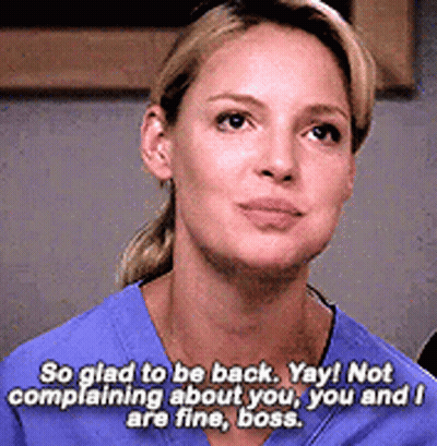 Woman In Blue Scrub Saying So Glad To Be Back Yay Not Complaining About You You And I Are Fine Boss GIF