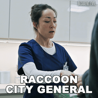 Woman In Blue Scrub Talking To Man Raccoon City General GIF