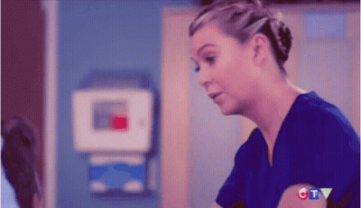 Woman In Blue Scrub Top Talking To Doctor GIF