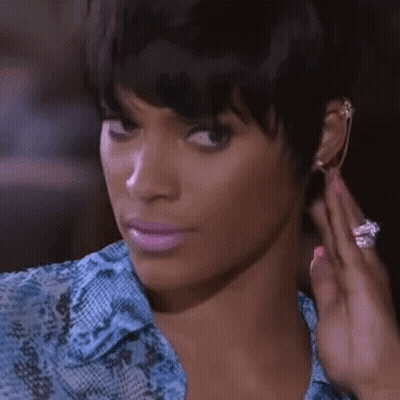 Woman In Blue Shirt Adjusting Earrings GIF