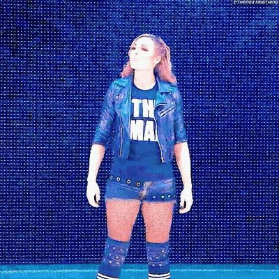 Woman In Blue Shirt And Denim Shorts In Front Of Blue Screen GIF