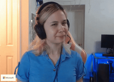 Woman In Blue Shirt And Headphones With Microsoft Logo GIF