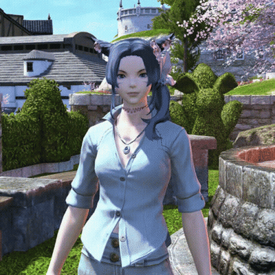 Woman In Blue Shirt And Necklace In Front Of Castle GIF