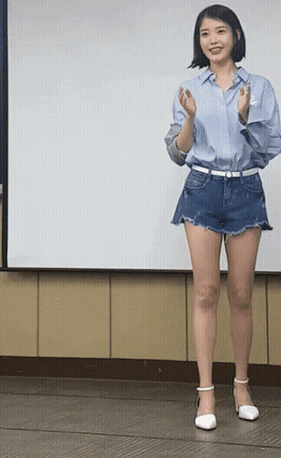 Woman In Blue Shirt And Shorts In Front Of White Board GIF