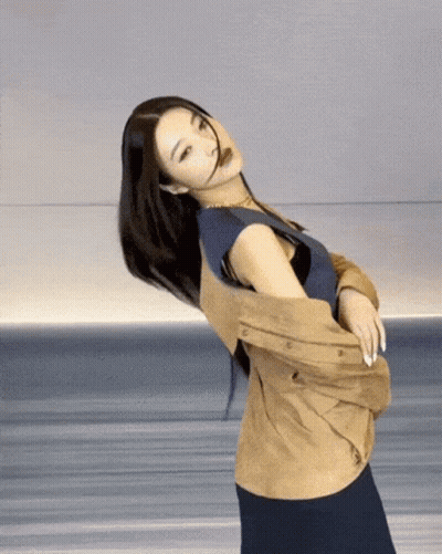 Woman In Blue Shirt And Tan Jacket GIF