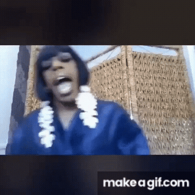 Woman In Blue Shirt And White Lei Sitting In Chair GIF