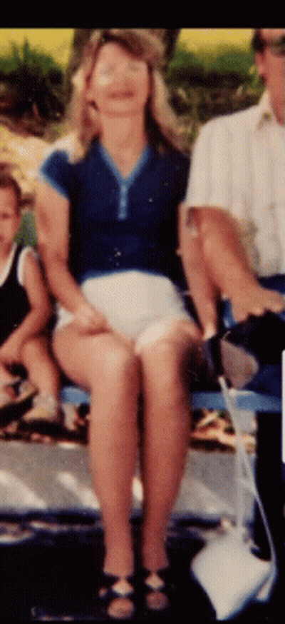 Woman In Blue Shirt And White Shorts Sitting With Man And Child GIF
