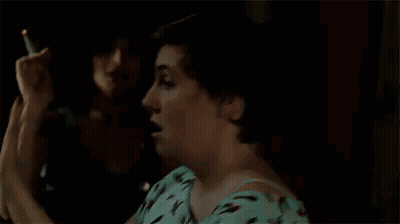 Woman In Blue Shirt Covering Eyes In Dark Room GIF