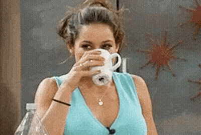 Woman In Blue Shirt Drinking From White Cup GIF