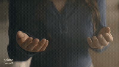 Woman In Blue Shirt Gesturing At Amazon Prime Logo GIF