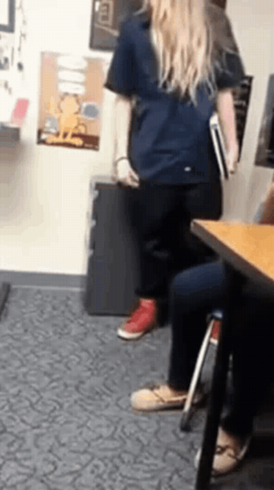 Woman In Blue Shirt Holding Book GIF